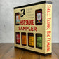 Hot sauce sampler box from Butterfly Bakery of Vermont on a wooden surface