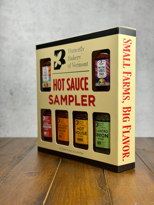 Hot sauce sampler box from Butterfly Bakery of Vermont on a wooden surface