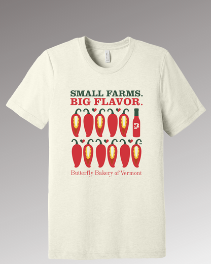 Front view of a cream colored t-shirt with a red chili peppers graphic positioned below 'Small Farms. Big Flavor.'