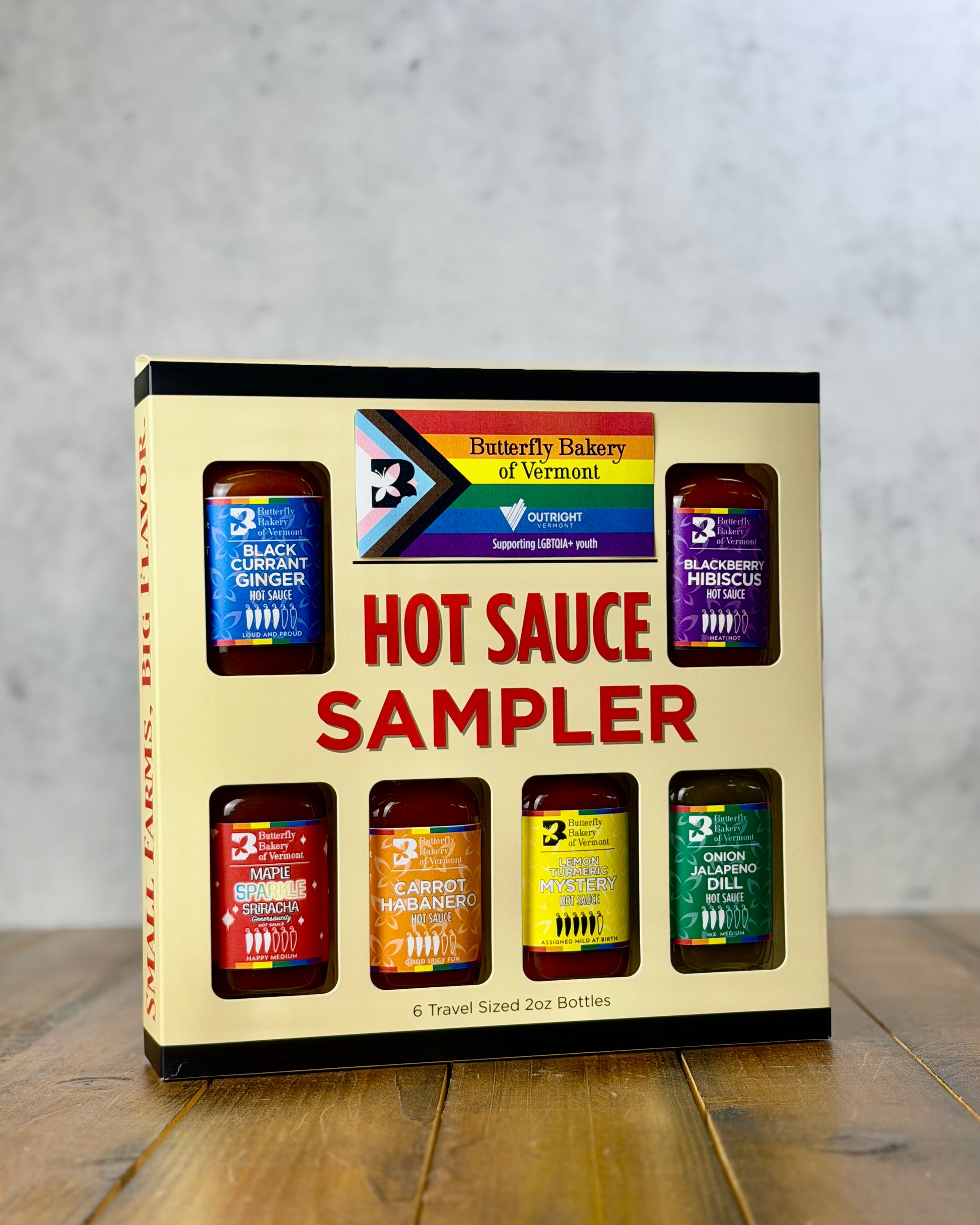 Butterfly Bakery of Vermont's 'Pride Pack' hot sauce sampler box on a wooden table