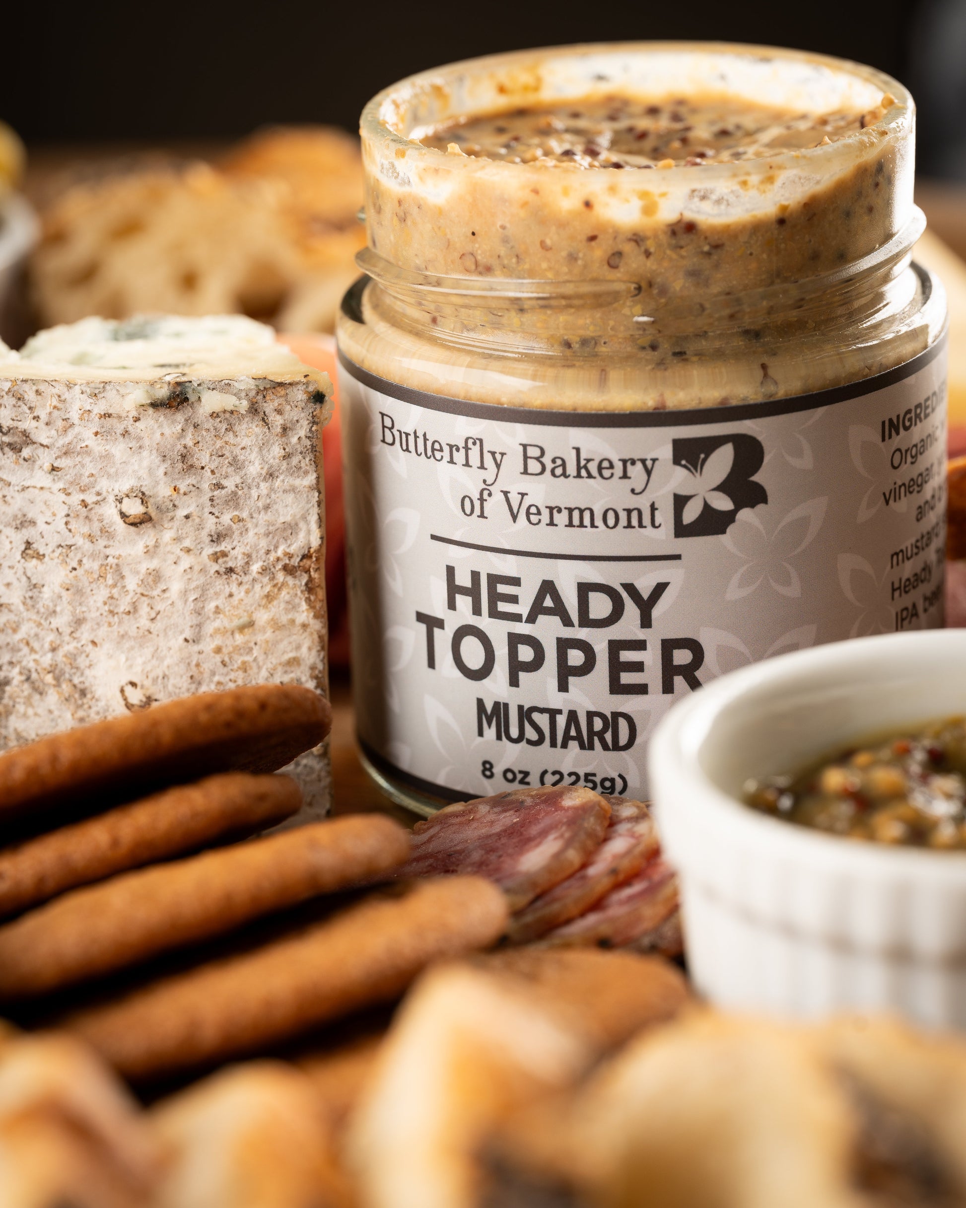 Butterfly Bakery of Vermont Heady Topper mustard surrounded by crackers, bread, cheese and charcuterie