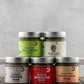 Butterfly Bakery of Vermont full line of mustards on a wood surface 