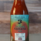 Bottle of Butterfly Bakery of Vermont Crushed Tomato Sauce against a wood background